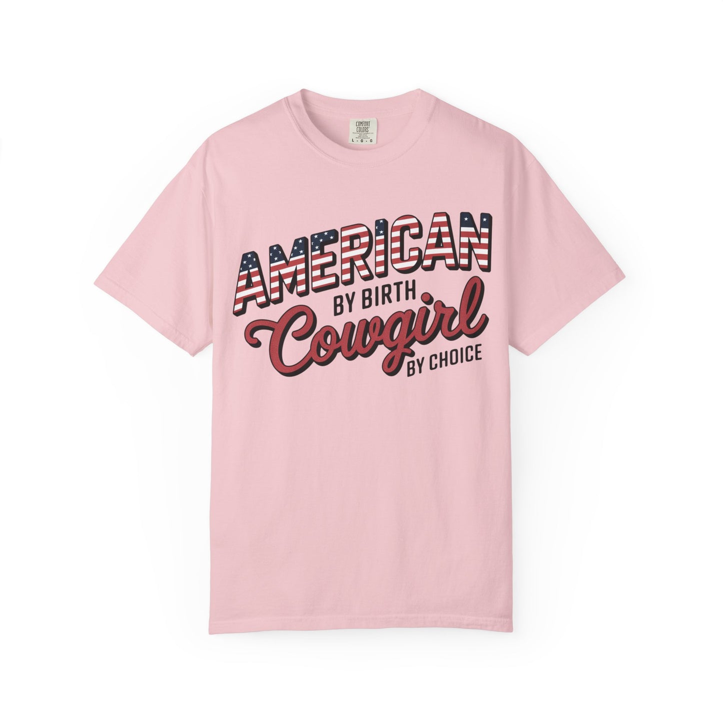 American by Birth Cowgirl by Choice tee with patriotic western lettering laid flat on white background in color blossom