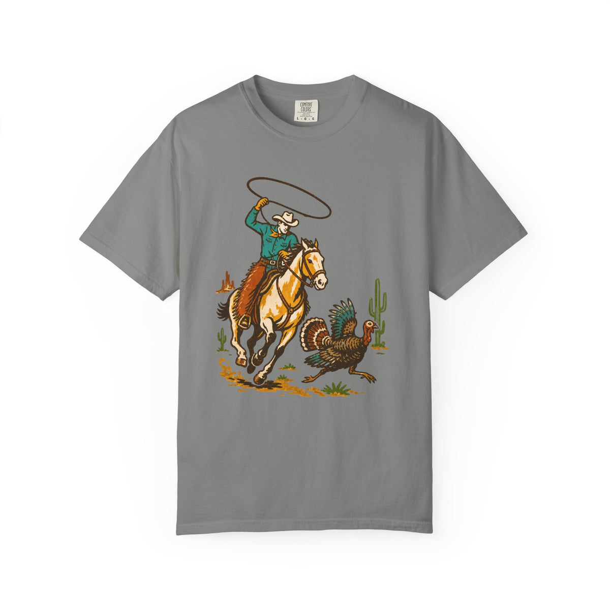 A gray short-sleeve crewneck t-shirt featuring a colorful graphic print of a cowboy riding a horse and chasing a turkey.