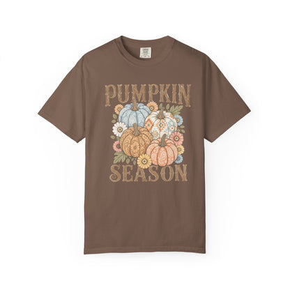 A brown short-sleeve crewneck t-shirt featuring a 'Pumpkin Season' graphic on the front with illustrated pumpkins, flowers, and a distressed font, displayed on a clean white background.