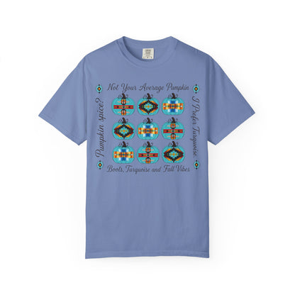 A light blue short-sleeve t-shirt with a graphic print featuring nine colorful geometric pumpkins arranged in a 3x3 grid, with text reading 'Not Your Average Pumpkin' and 'Pumpkin Spice Boots, Tarotique and Fall Vibes'.