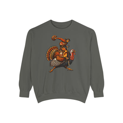 A dark gray crewneck sweatshirt featuring a graphic print of a cowboy riding a turkey, with a cowboy boot and a small cowboy figure on his back, displayed against a solid white background.