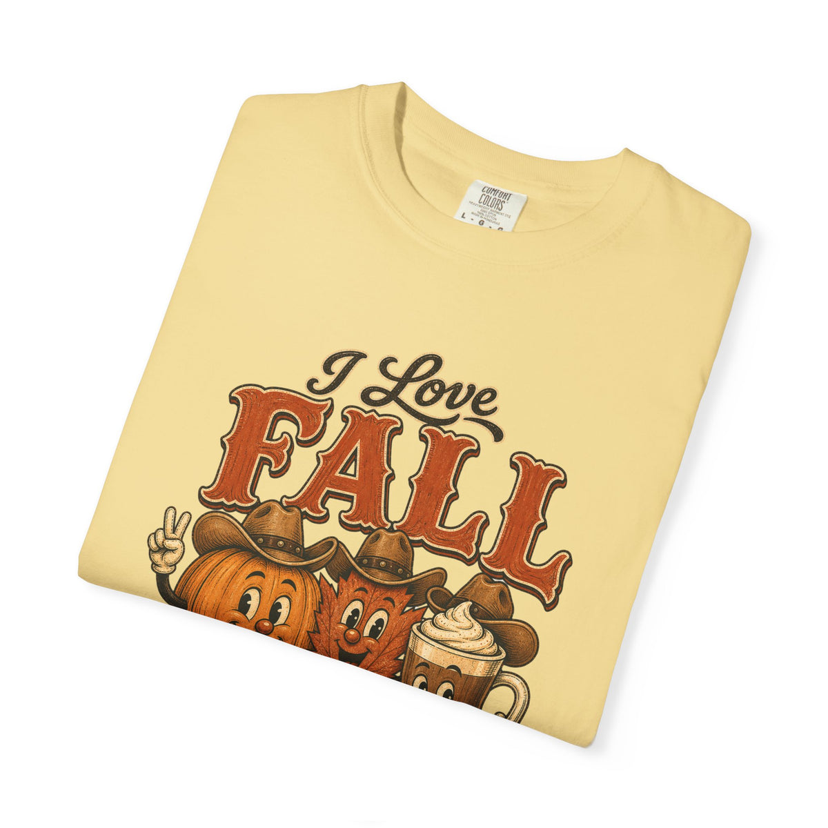 A folded light yellow t-shirt with a 'I Love FALL' graphic featuring cartoon pumpkins wearing cowboy hats and a hot chocolate mug, displayed on a clean white background.