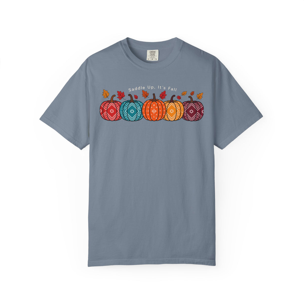 A slate blue short-sleeve t-shirt with a colorful graphic of four patterned pumpkins and the text 'Gaddle up, It's Fall' across the chest, displayed on a clean white background.