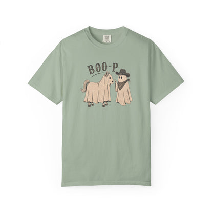 Blue t-shirt with graphic of horse ghost and cowboy ghost and text on a white background