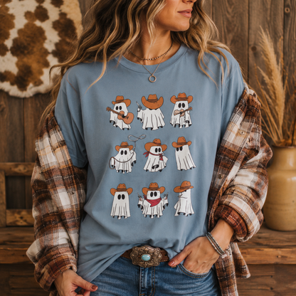 A woman wearing a light blue graphic t-shirt with cartoon ghosts in cowboy hats, styled with a brown and white plaid flannel shirt over her shoulders and blue jeans.