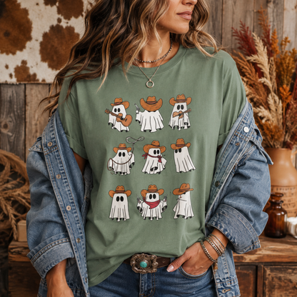 A woman wearing an oversized sage green graphic t-shirt with cartoon ghosts wearing cowboy hats, styled with an open blue denim jacket.