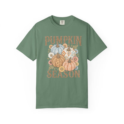 A sage green short-sleeve t-shirt with a 'Pumpkin Season' graphic on the chest, featuring illustrated pumpkins and flowers in autumn colors, displayed on a clean white background.