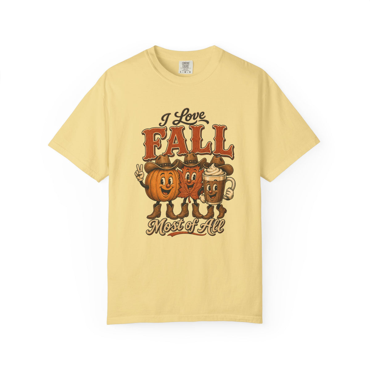 A pale yellow short-sleeve t-shirt with a vintage-style autumn graphic on the front. The graphic features the text 'I Love FALL Most of All' above three cartoon characters representing a pumpkin, a hot dog, and a mug, all in warm orange, brown, and cream tones.