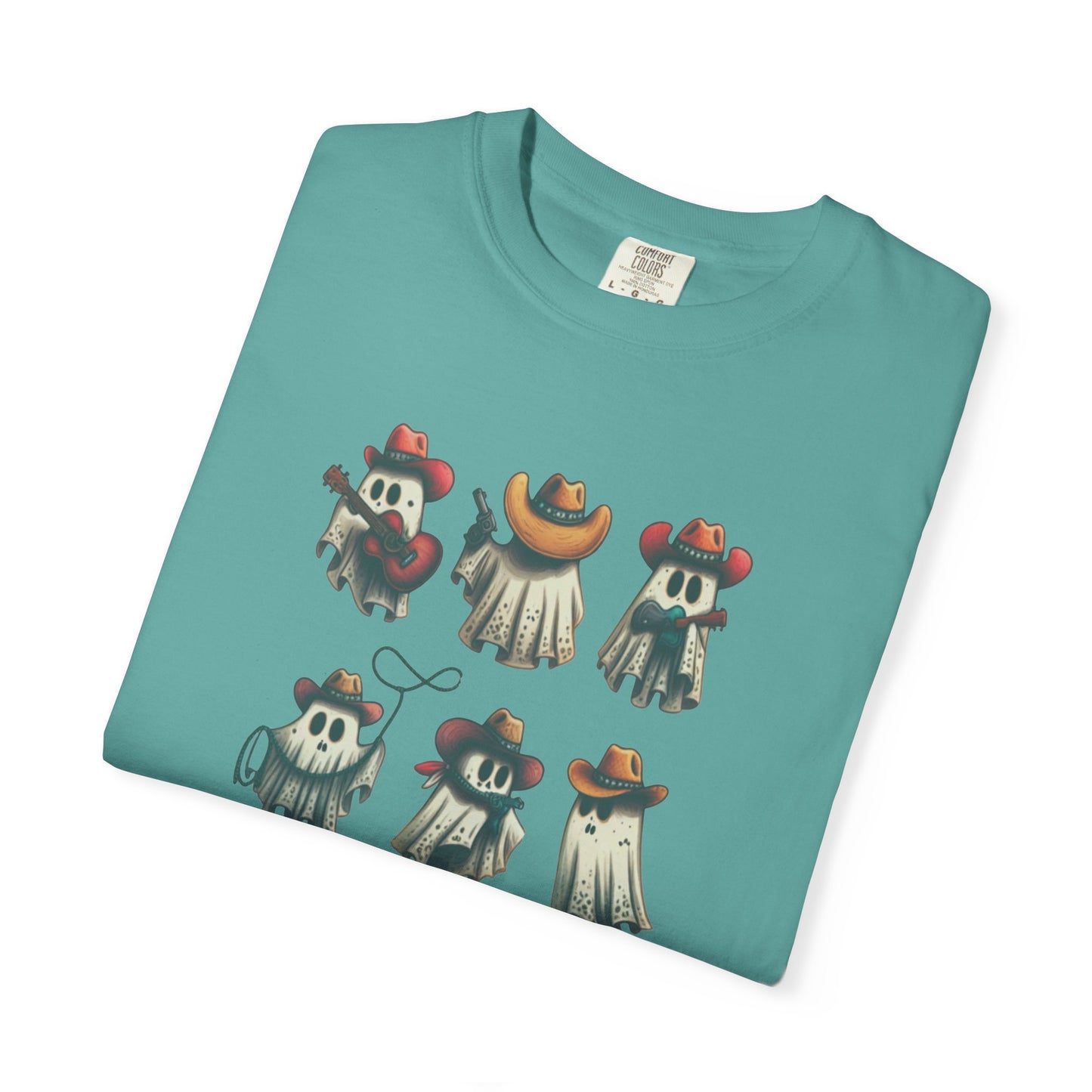 A folded teal t-shirt on a white background, featuring a graphic print of six cartoon ghosts dressed in cowboy attire.