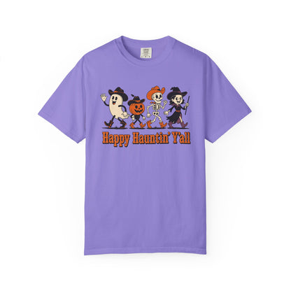 A purple short-sleeve crewneck t-shirt featuring a cartoon graphic of four Halloween characters and the text 'Happy Haunthin' Y'all' printed on the chest, displayed against a plain white background.