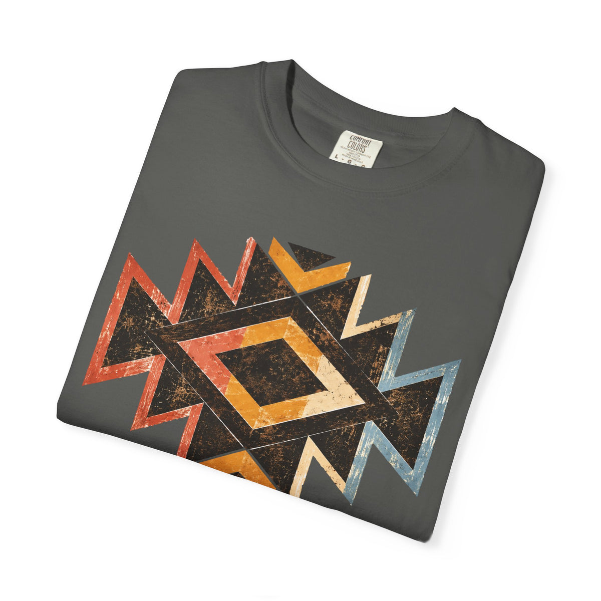 A dark gray folded t-shirt featuring a distressed geometric diamond pattern in orange, beige, black, and blue, displayed on a clean white background.