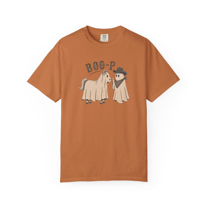 A rust-orange short-sleeve t-shirt with a cartoon graphic of a horse and a ghost wearing a cowboy hat and bandana under the text 'BOO-P'.
