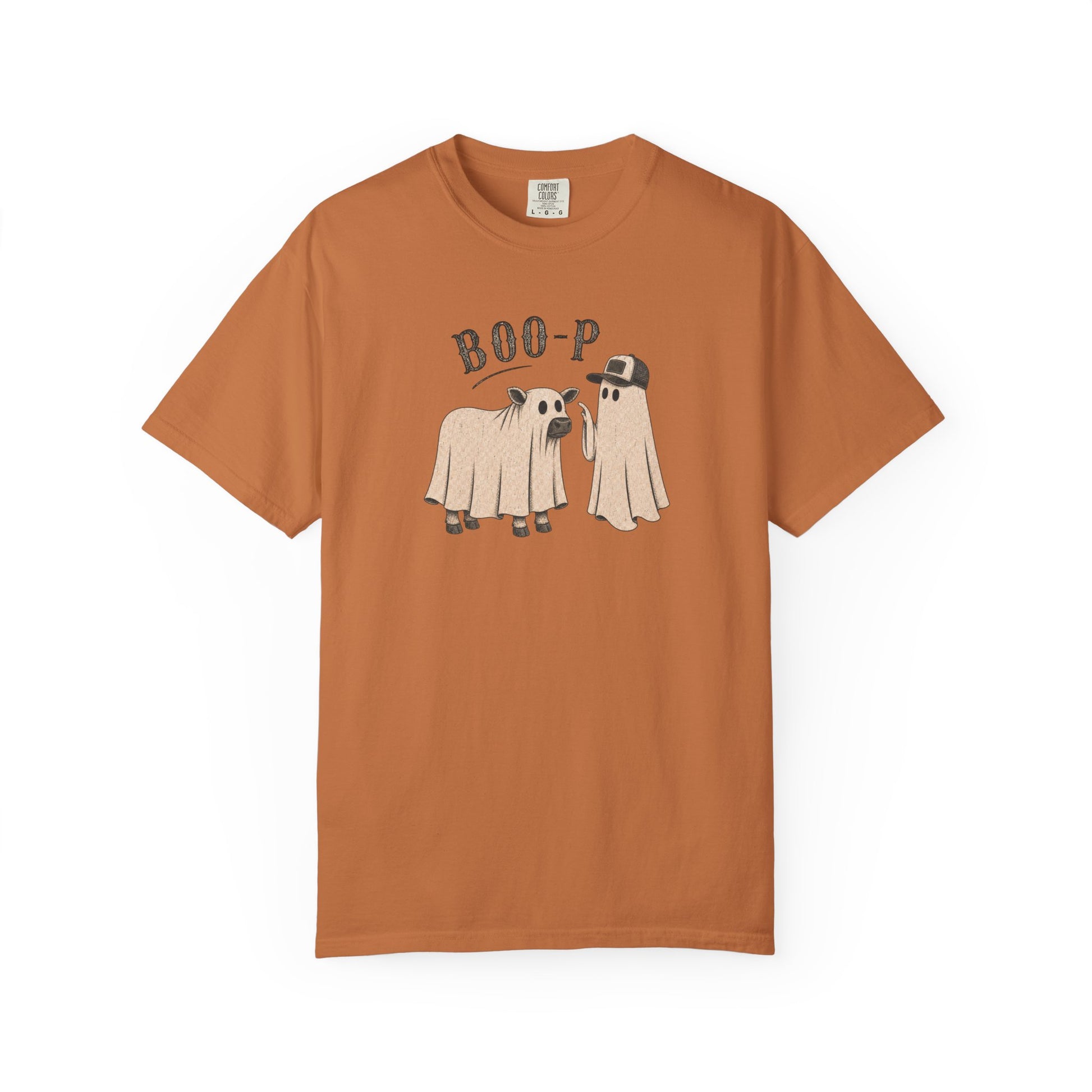 A short-sleeve crewneck t-shirt in a muted terracotta or salmon pink color, featuring a graphic of a campfire with pine trees and the text 'RILEY'S BACH CAMP BACH EST. 2026' printed on the front.