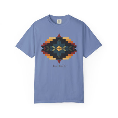 A light blue crewneck t-shirt featuring a central  geometric design in a Southwestern style with red, orange, yellow, and dark blue colors, and the text 'Bronc & Brand Co.' printed below.