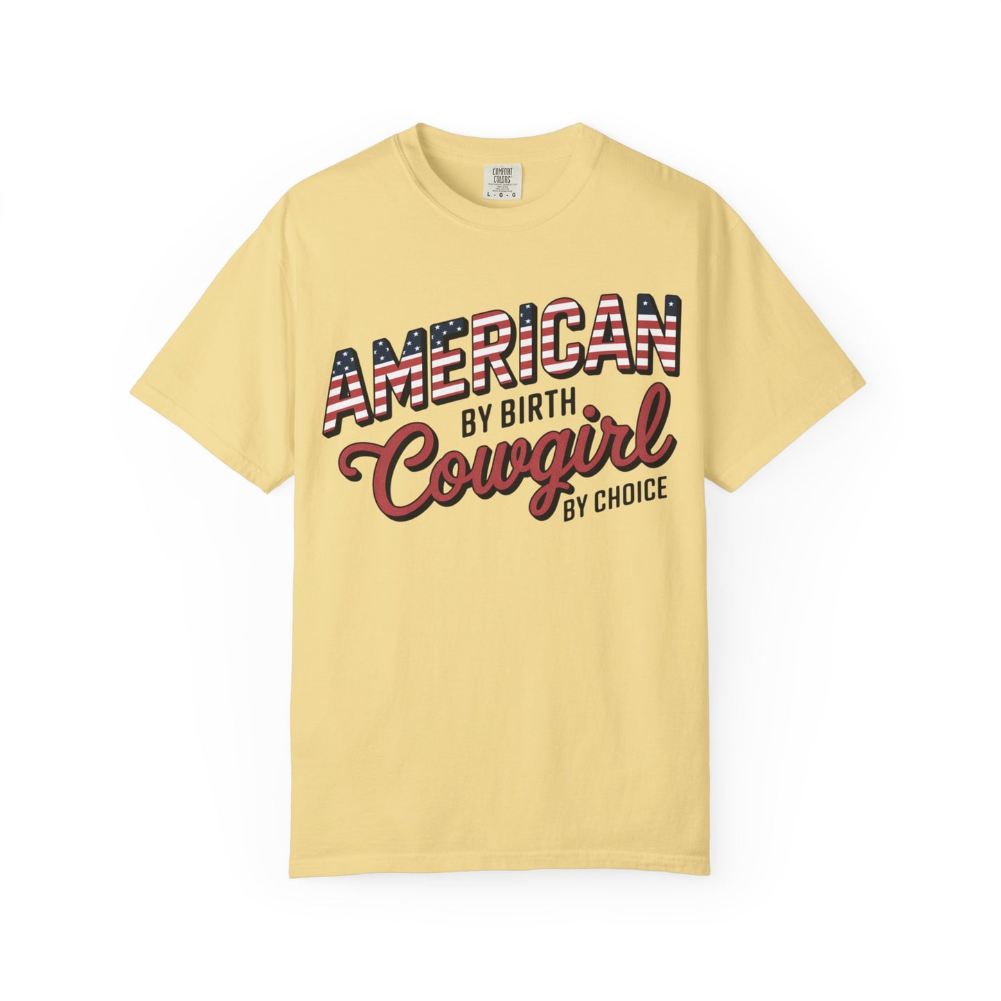 American by Birth Cowgirl by Choice tee with patriotic western lettering laid flat on white background in butter color