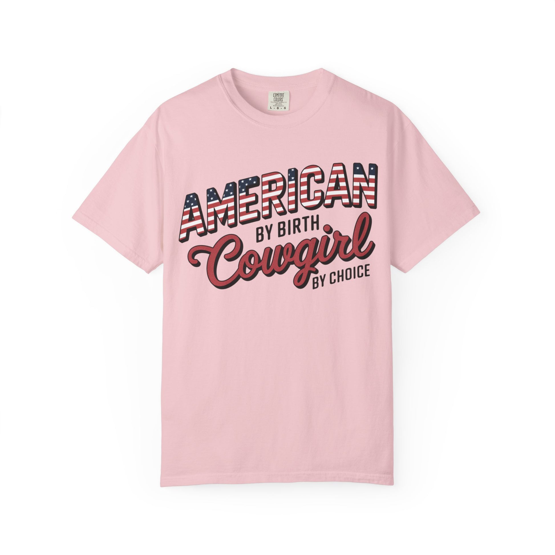 American by Birth Cowgirl by Choice tee with patriotic western lettering laid flat on white background in color blossom