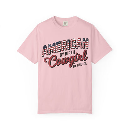 American by Birth Cowgirl by Choice tee with patriotic western lettering laid flat on white background in color blossom