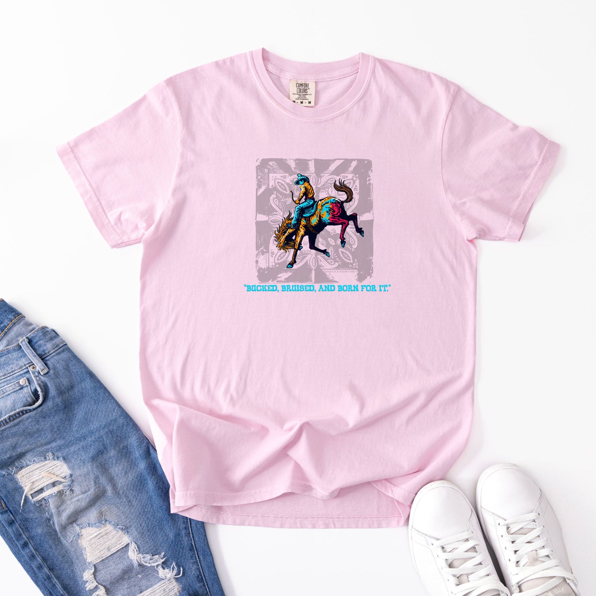 Bruised Born & For It Western Tee laid out with jeans and shoes in color blossom