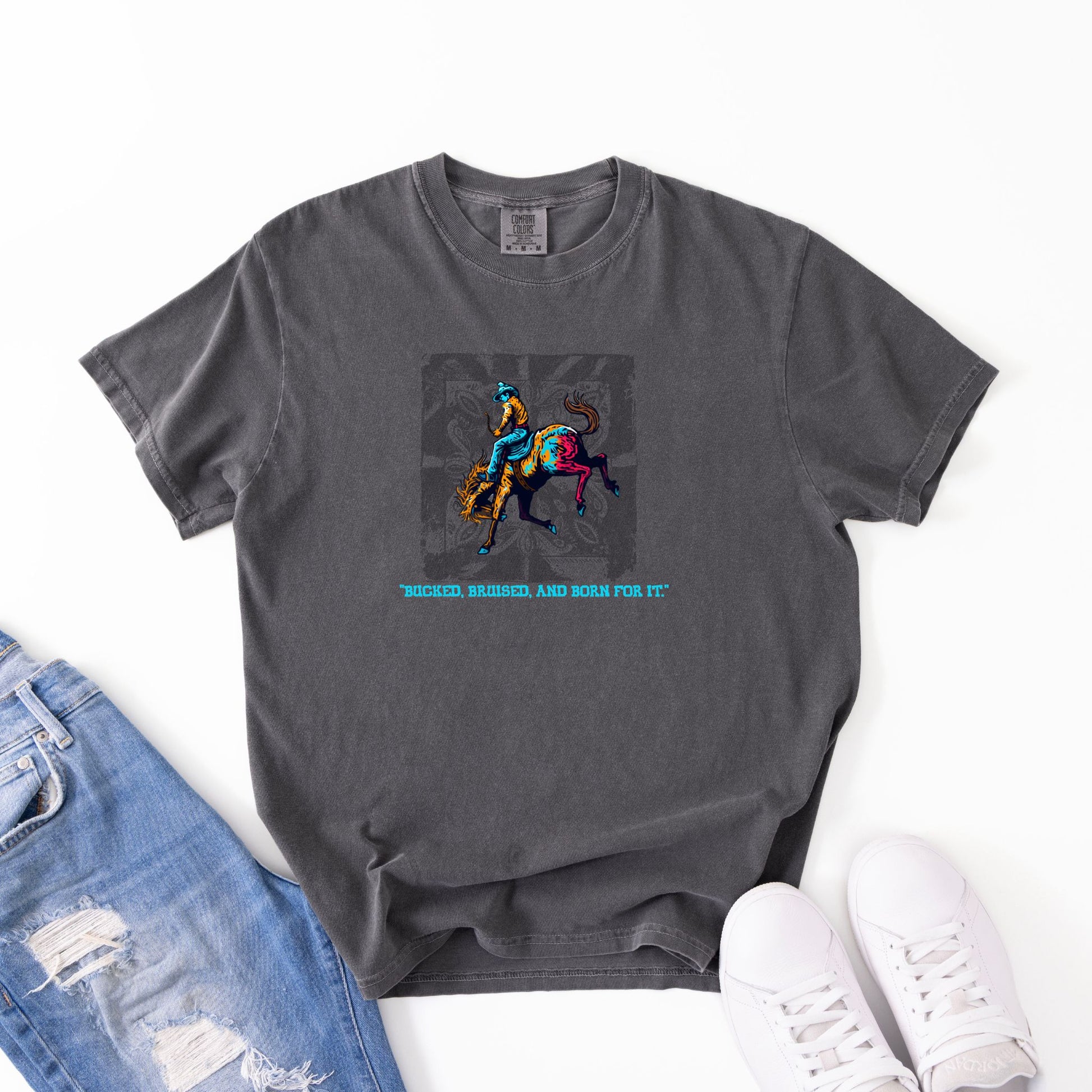 Bruised Born & For It Western Tee laid out with jeans and shoes in color pepper