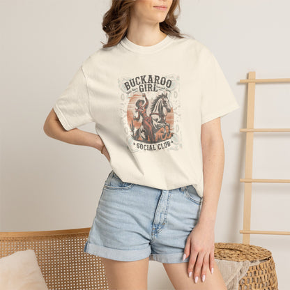 Buckaroo Spirits tee with vintage cowgirl riding horse graphic and western paisley border on model in color ivory