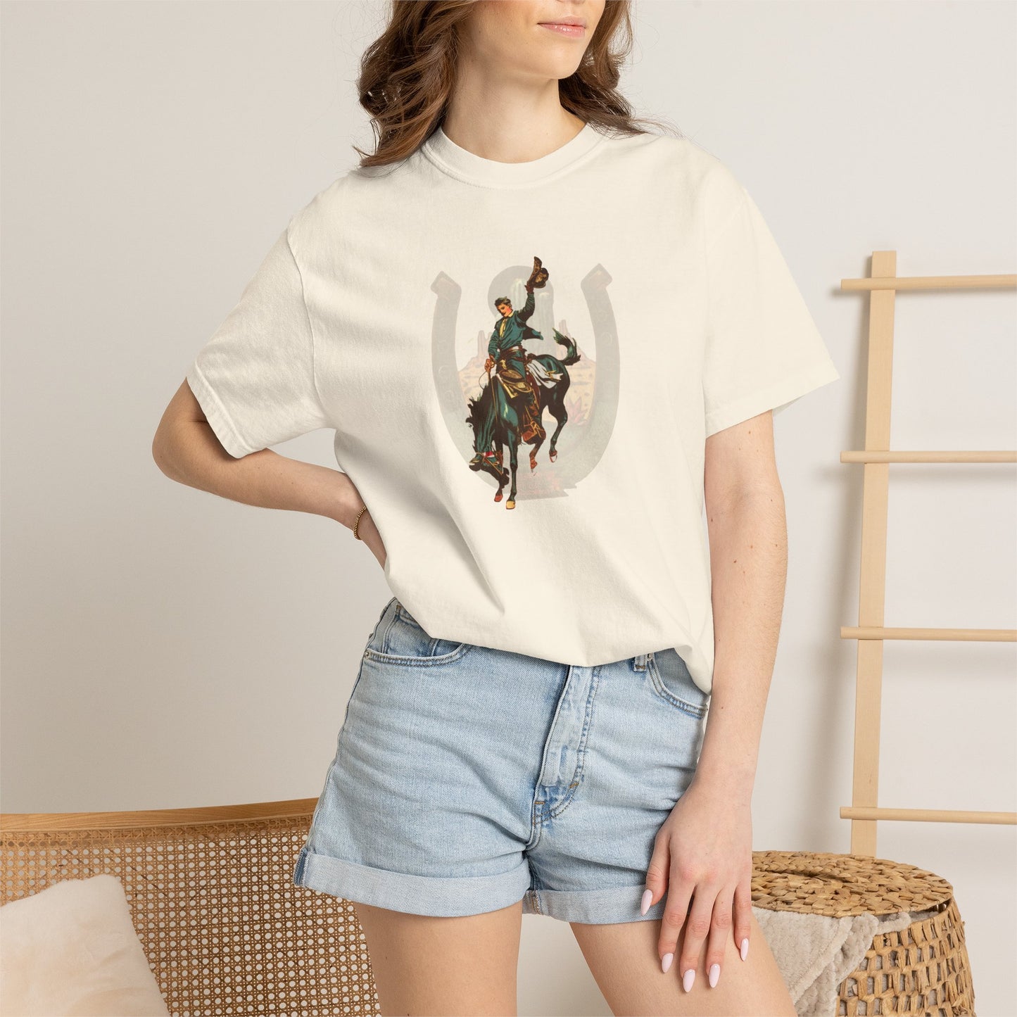 Buckaroo horseshoe tee with vintage bronc rider and desert cactus graphic on model in ivory