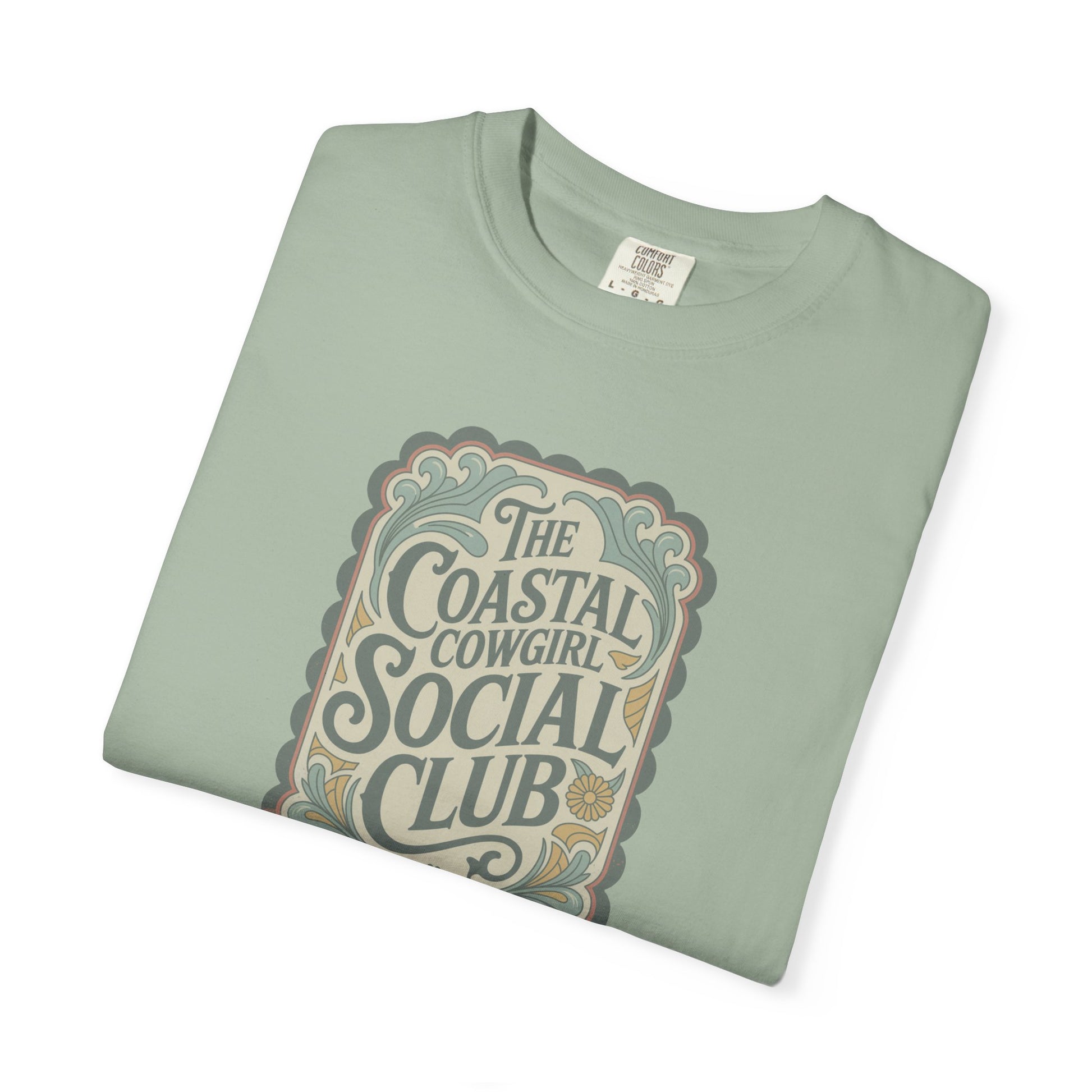 Coastal Cowgirl Clubhouse tee with vintage western sign print and retro coastal colours folded in color bay