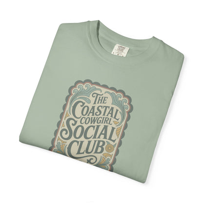 Coastal Cowgirl Clubhouse tee with vintage western sign print and retro coastal colours folded in color bay