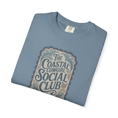 Coastal Cowgirl Clubhouse tee with vintage western sign print and retro coastal colours folded in color ice blue