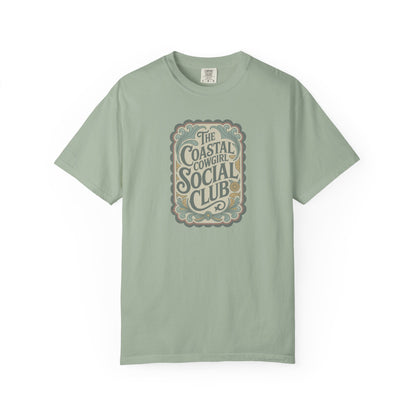 Coastal Cowgirl Clubhouse tee with vintage western sign print and retro coastal colours front view in color bay