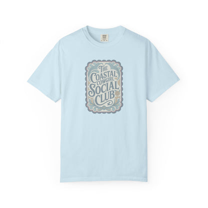 Coastal Cowgirl Clubhouse tee with vintage western sign print and retro coastal colours front view in color chambray