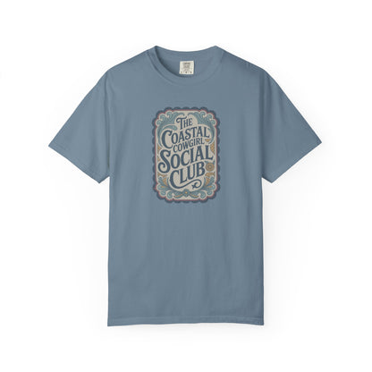 Coastal Cowgirl Clubhouse tee with vintage western sign print and retro coastal colours front view in color ice blue