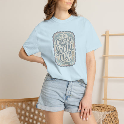 Coastal Cowgirl Clubhouse tee with vintage western sign print and retro coastal colours on model in chambray
