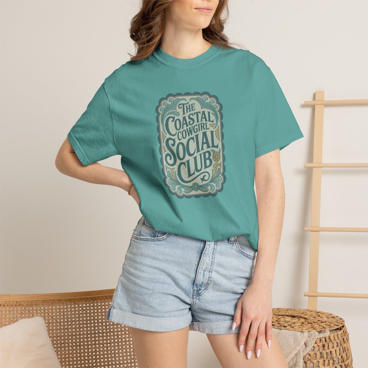 Coastal Cowgirl Clubhouse tee with vintage western sign print and retro coastal colours on model in seafoam