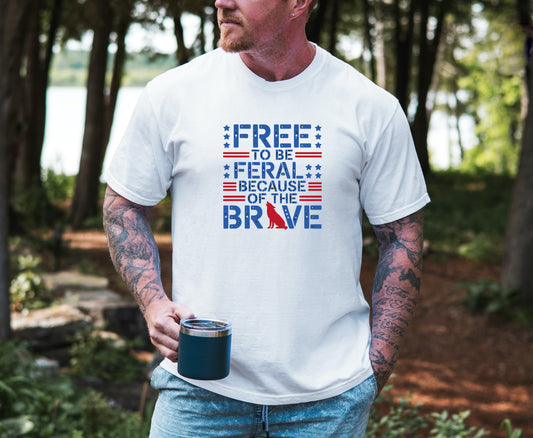 Free to Be Feral tee with patriotic lettering and red wolf graphic on  a male model with lake background