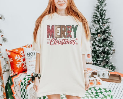 Merry Christmas Western Comfort Colors t-shirt with colourful patterned lettering, script text, and snowflake accents