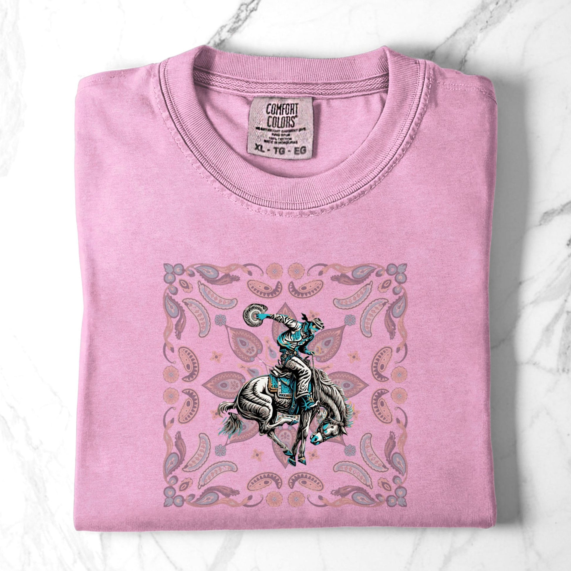 Paisley bronc rider western tee laid flat in color blossom