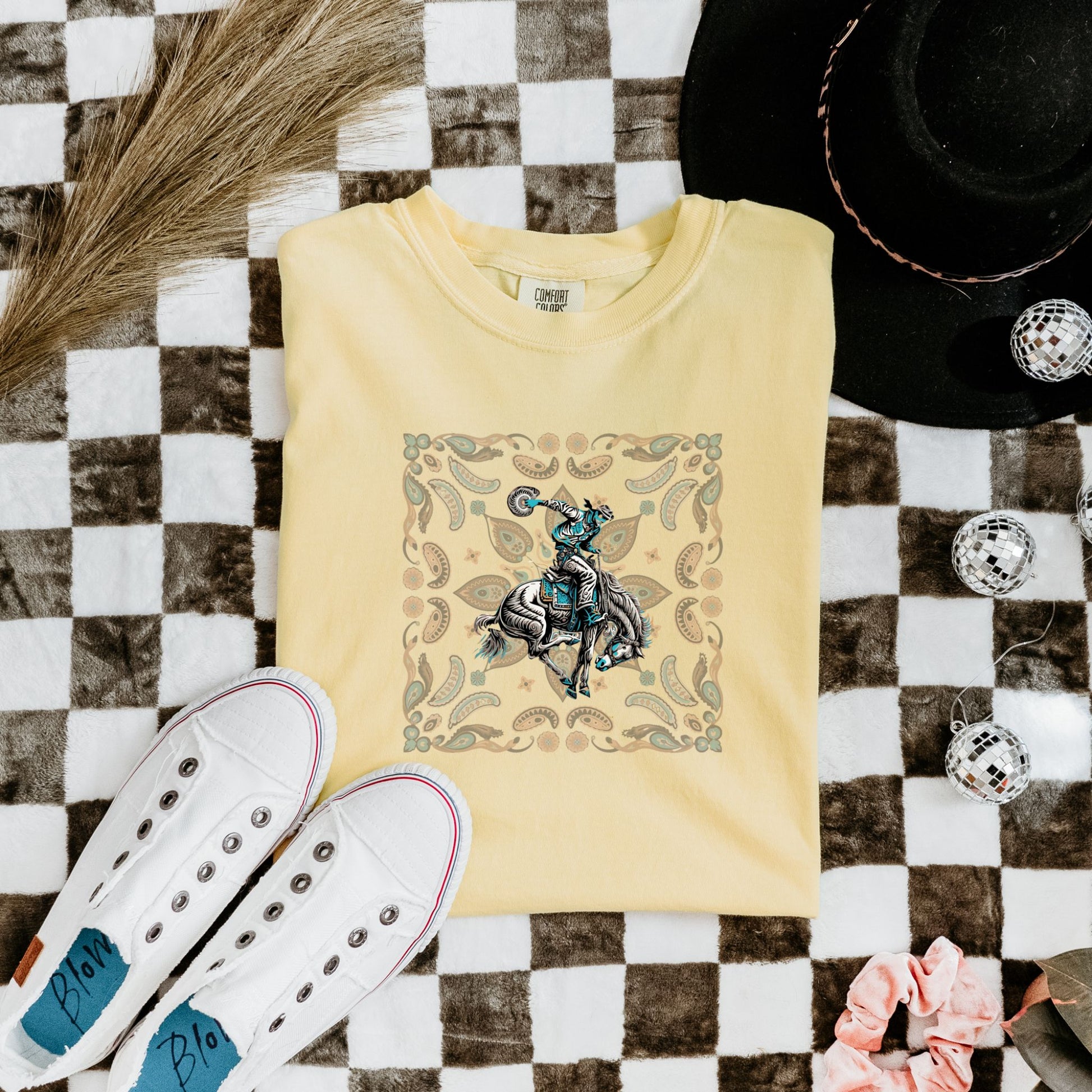 Paisley bronc rider western tee laid flat in color butter