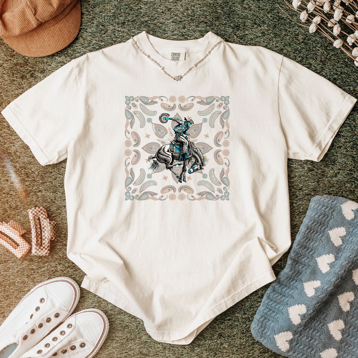 Paisley bronc rider western tee laid flat in color ivory