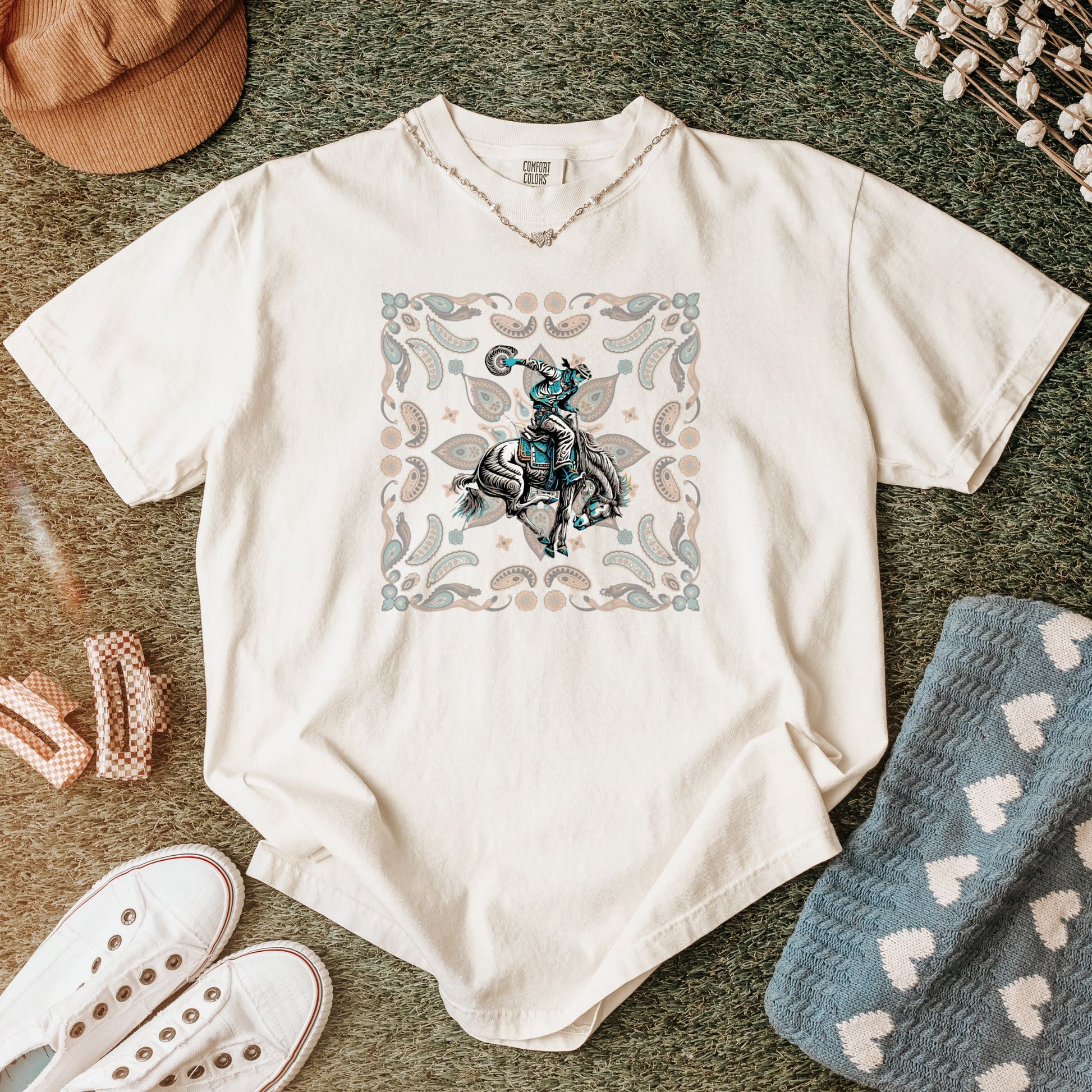 Paisley bronc rider western tee laid flat in color ivory