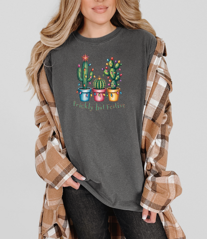 Prickly but Festive Comfort Colors Christmas cactus t-shirt with three potted cacti and holiday lights