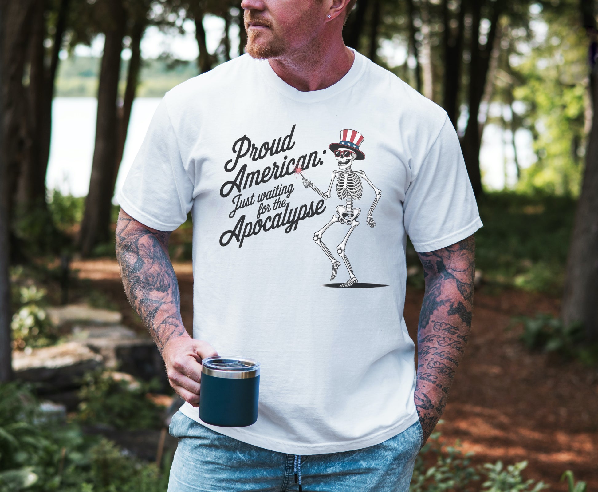 Man wearing a white t-shirt with a bronc and brand co skeleton graphic and text, standing outdoors.