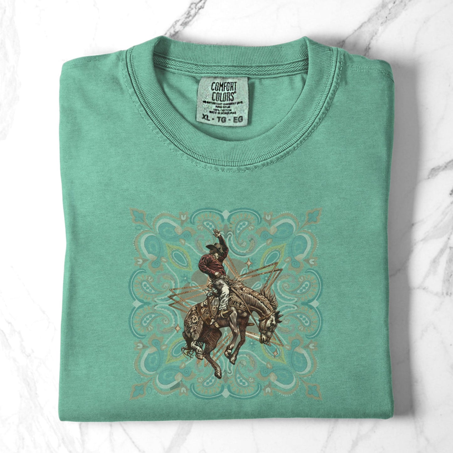 Rodeo spirit bronco tee folded in color island reef