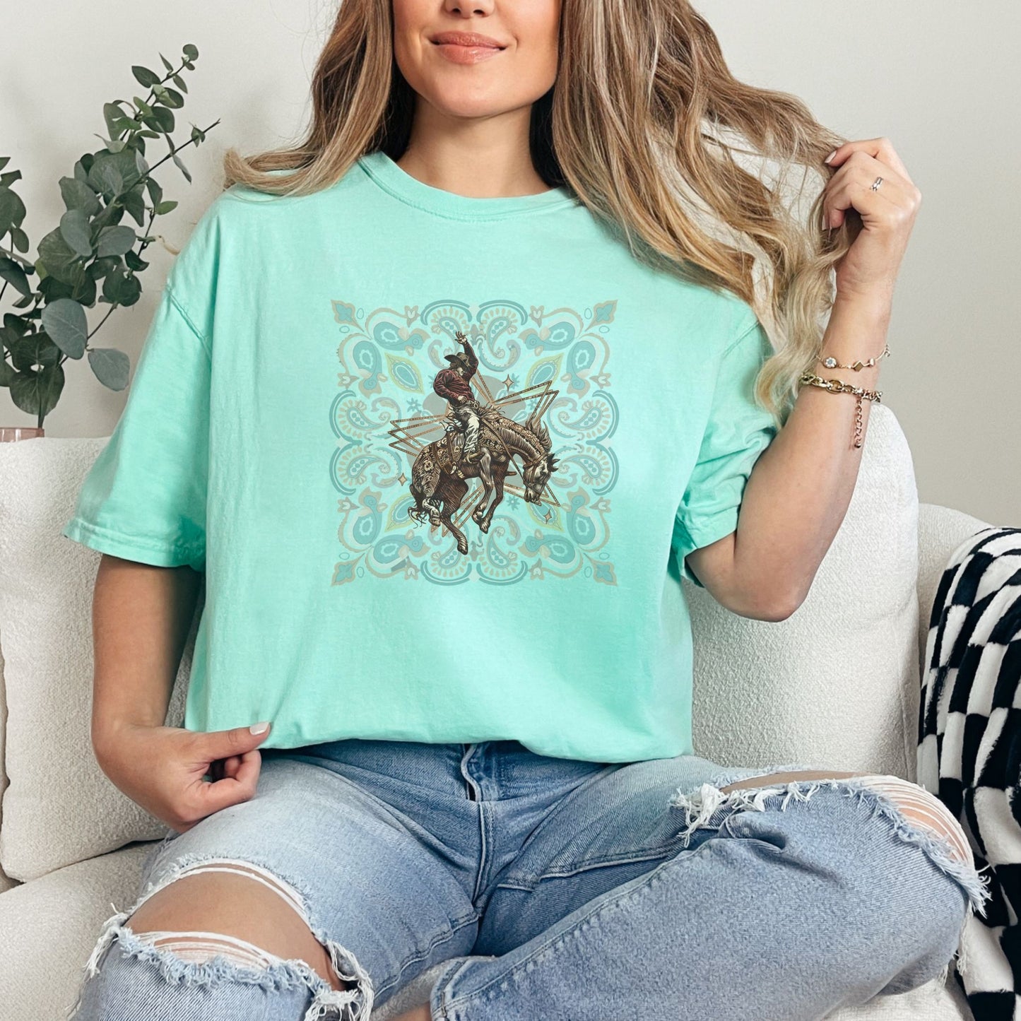 Rodeo spirit bronco tee on model in color island reef