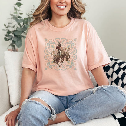 Rodeo spirit bronco tee on model in color peachy