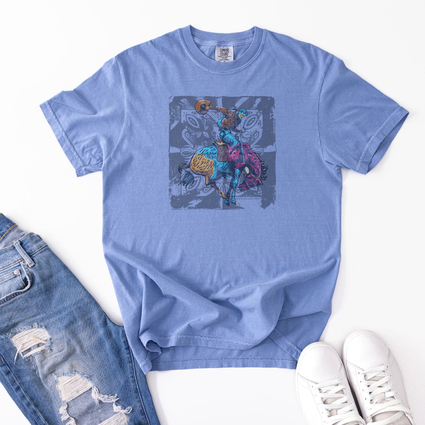 Vintage Bronc Spirit Tee laid out with jeans and shoes in color denim