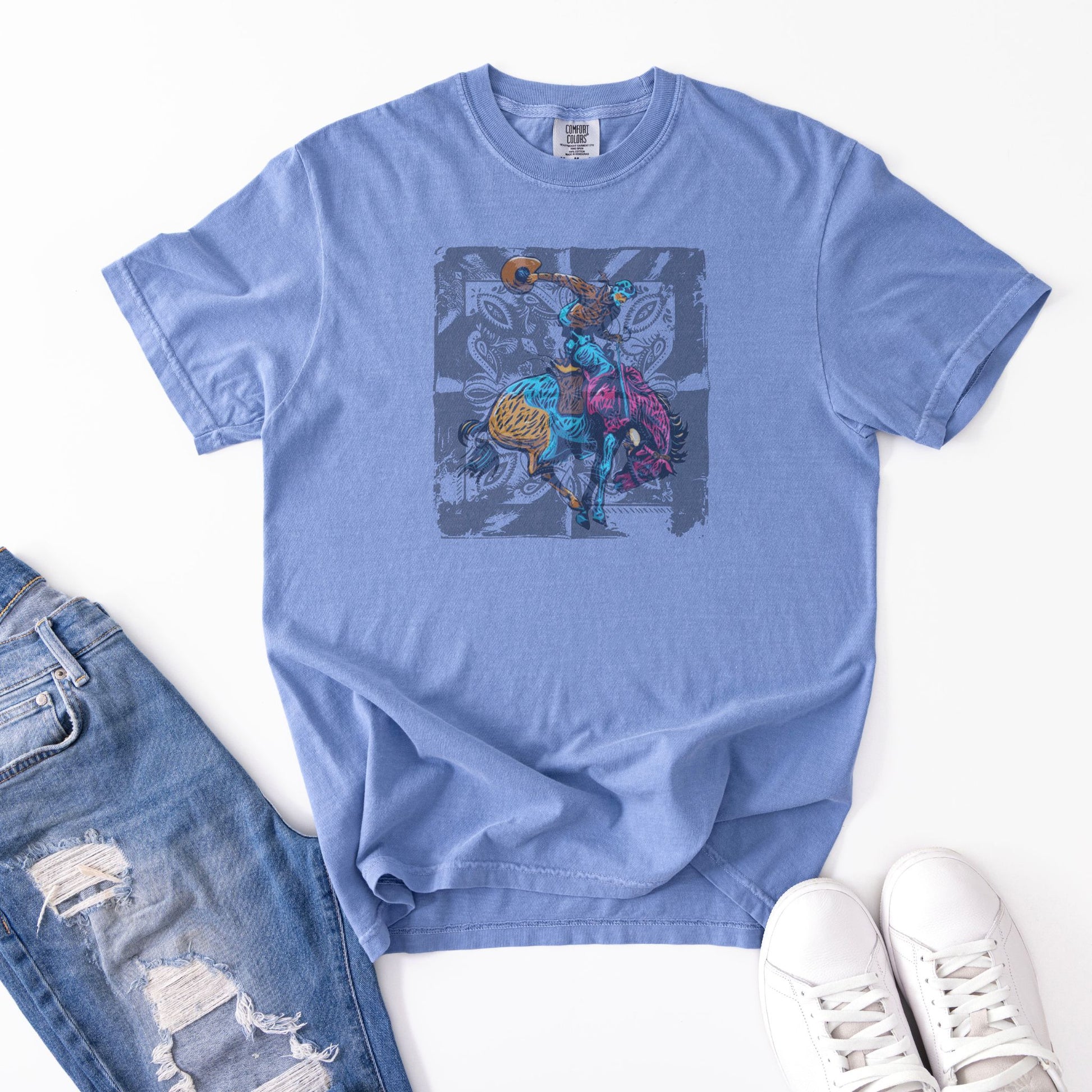 Vintage Bronc Spirit Tee laid out with jeans and shoes in color denim