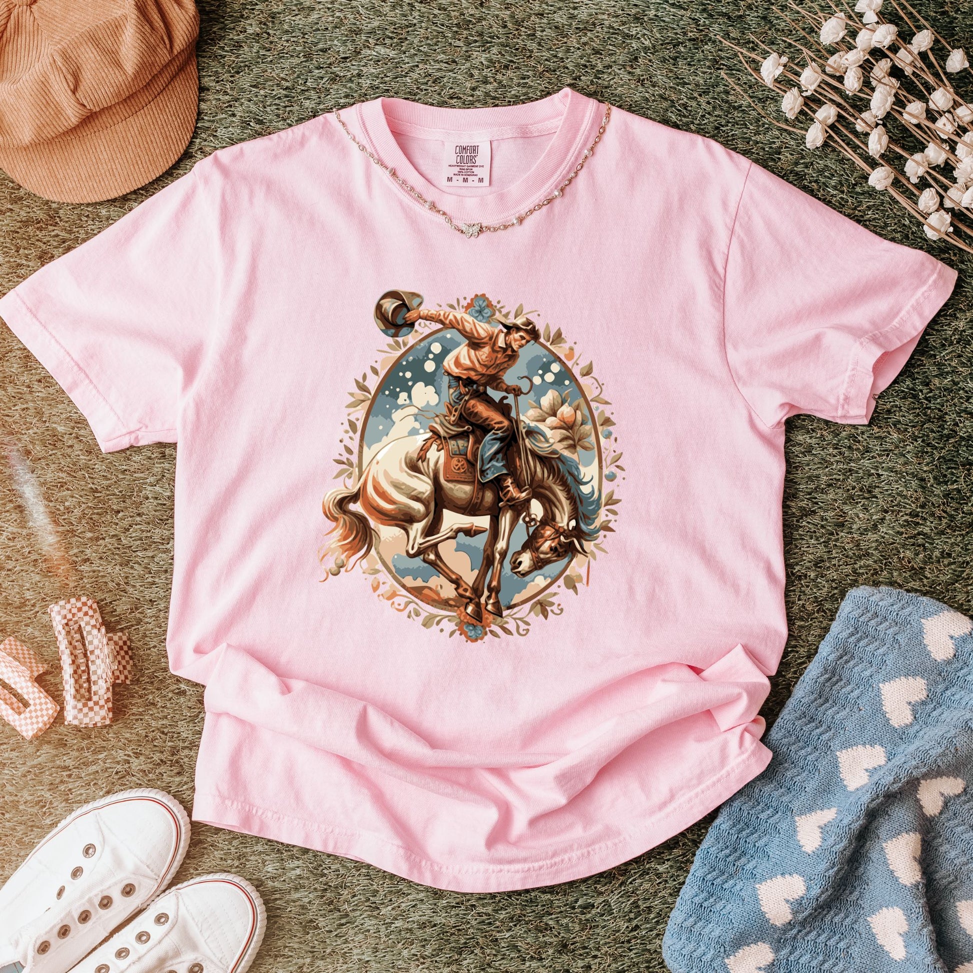 Vintage floral cowgirl tee laid out with props in color blossom