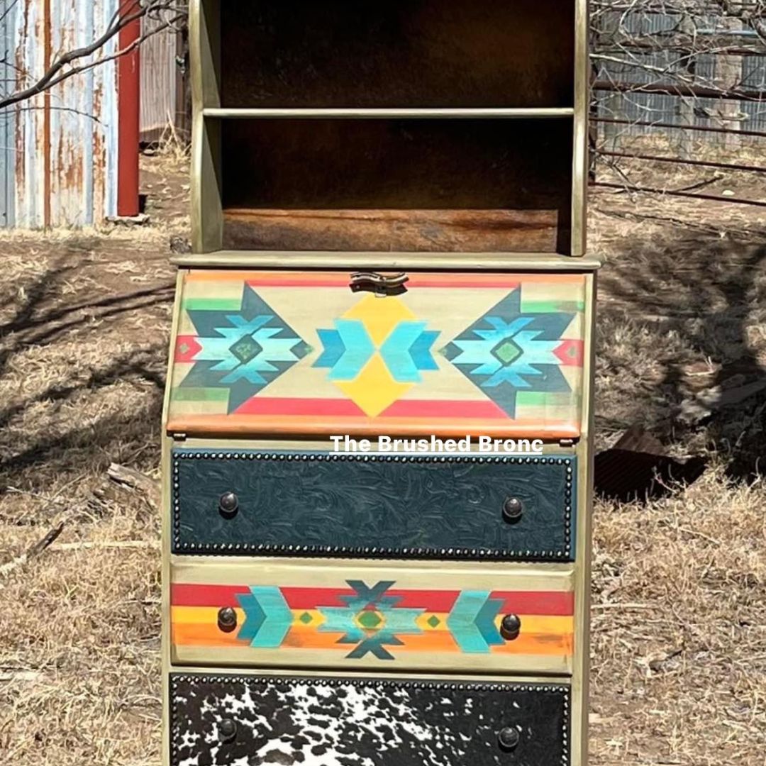 a piece of furniture hand painted by the brushed bronc